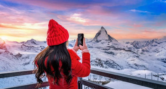 photo of tourist taking photo at Matterhorn and swiss alps in Zermatt, Switzerland.