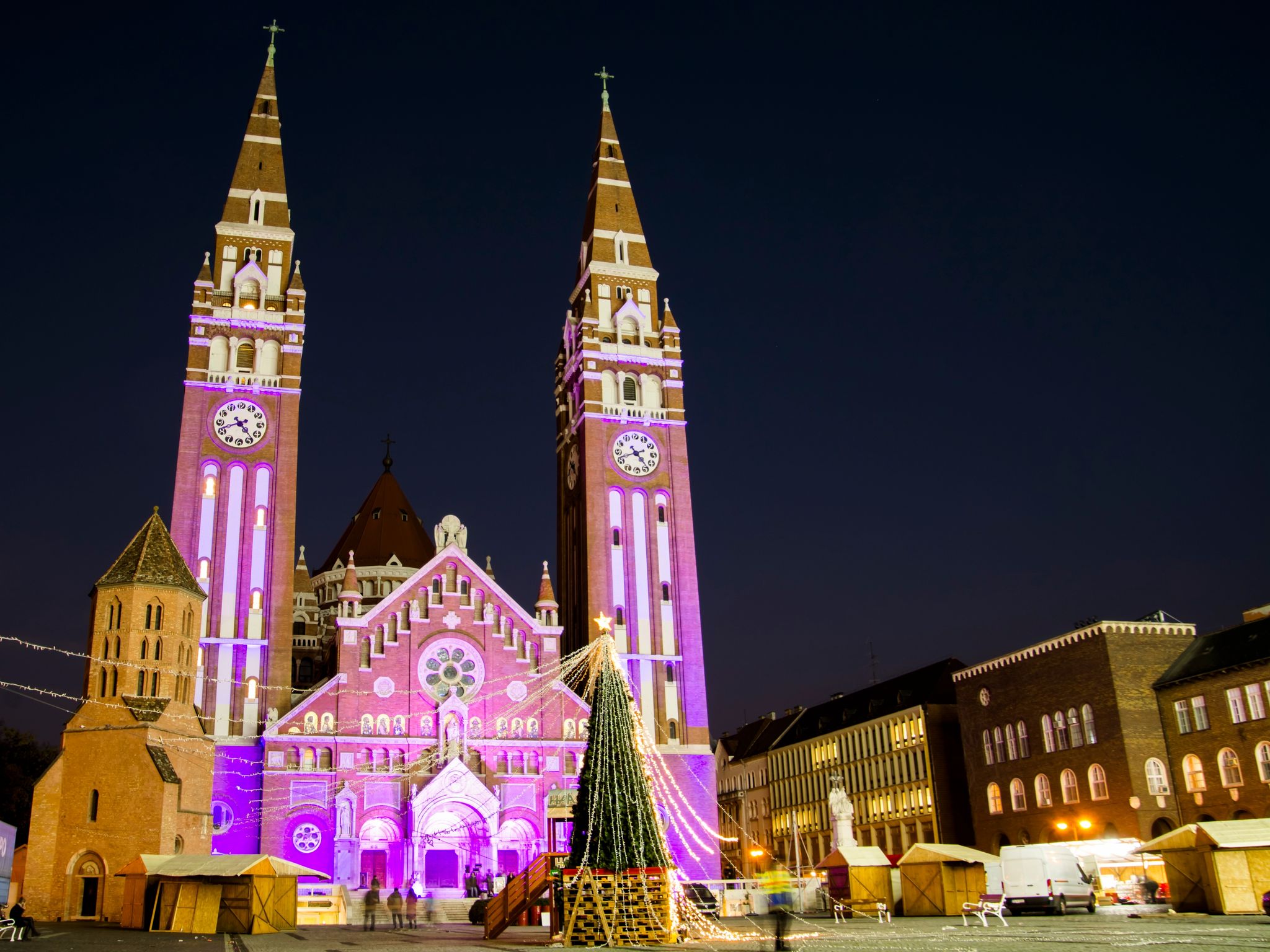photo of view The Votive Church and Cathedral of Our Lady of Hungary in the evening on World Prematurity Day 2022 Szeged, Hungary.