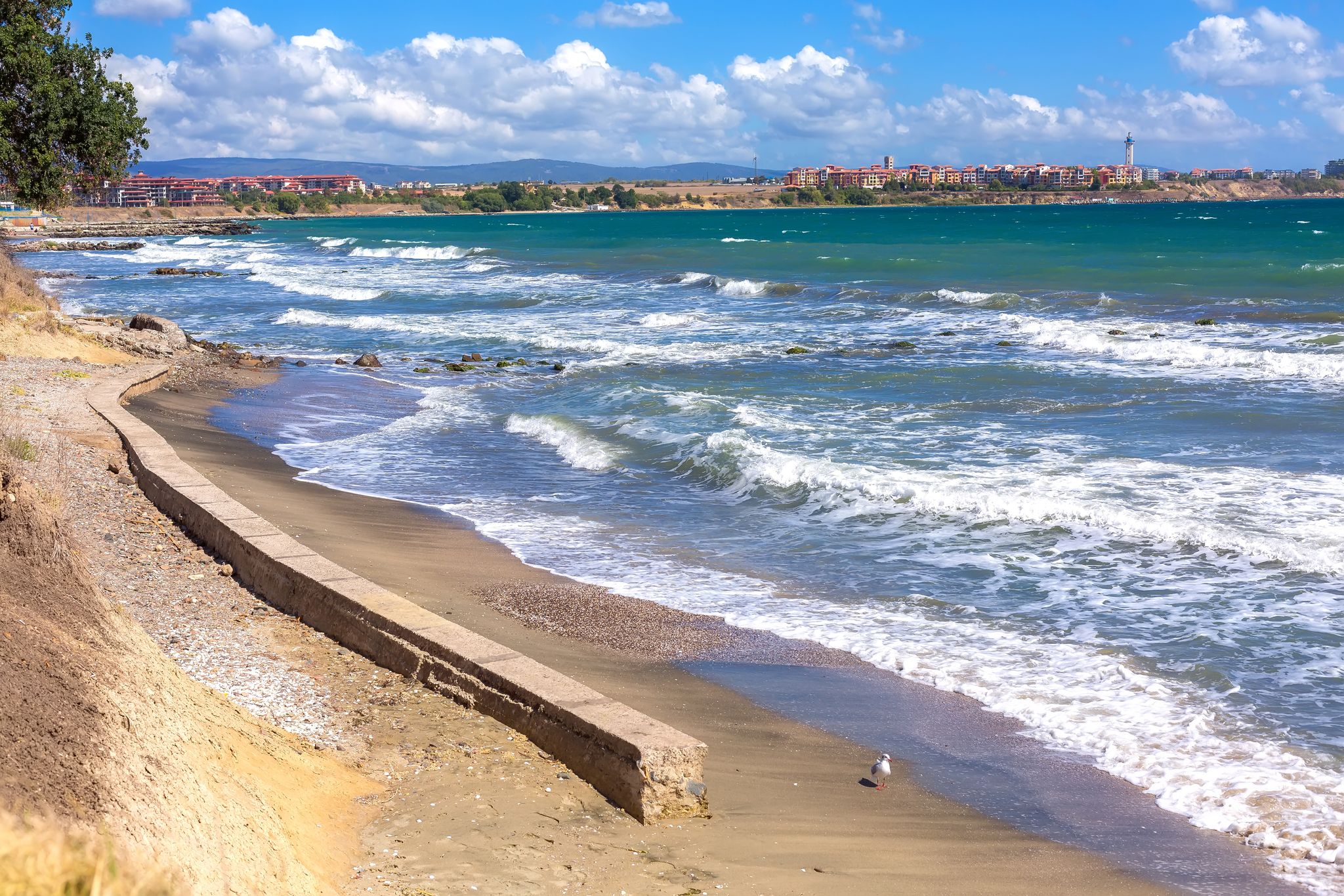 Aheloy, Bulgaria coastline, turquoise sea waves beach panorama background and Ravda town on the Black Sea