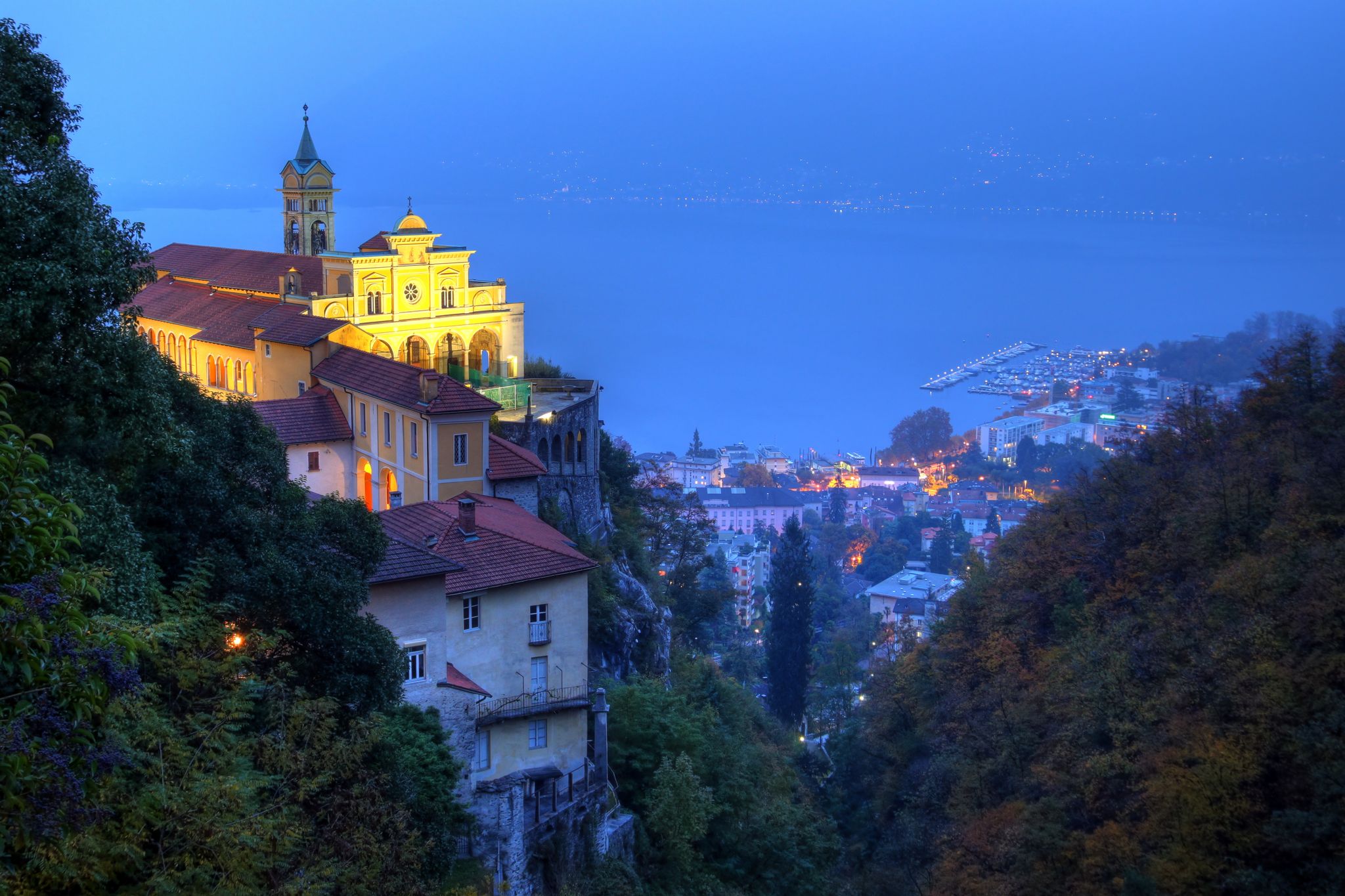 photo of night view of Madonna del Sasso, Switzerland. The Madonna del Sasso is a sanctuary and pilgrimage church in Orselina, above the city of Locarno in Switzerland.