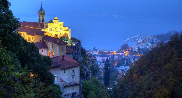 photo of night view of Madonna del Sasso, Switzerland. The Madonna del Sasso is a sanctuary and pilgrimage church in Orselina, above the city of Locarno in Switzerland.