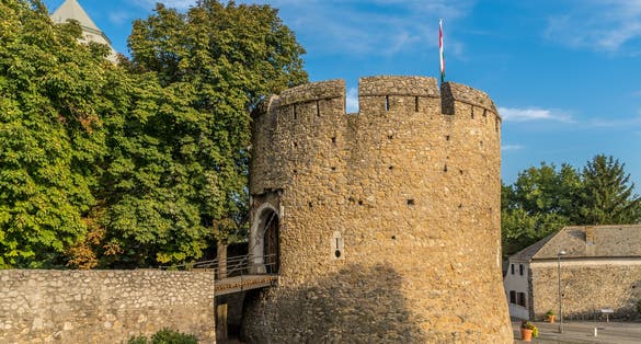 Summer view of the barbakan of Pecs, medieval circular defensive gate tower with loopholes, draw ridge, moat protecting the town from Turkish invasion
