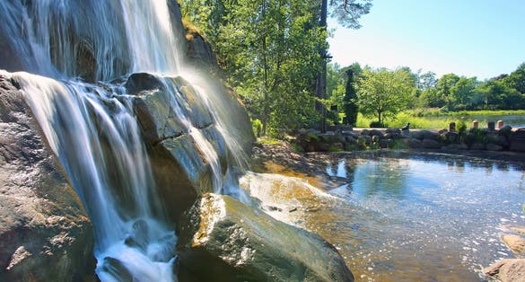 Photo of beautiful waterfall in Sapokka water park. It is a charming city center park, Kotka, Finland.
