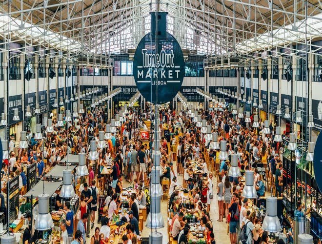 Crowds enjoying food and drinks at Time Out Market Lisboa, a must-visit culinary hotspot in Portugal in August..jpg