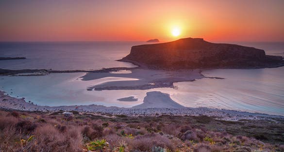 photo of view of Sunset over island Gramvousa and the Balos beach in Crete, Greece.