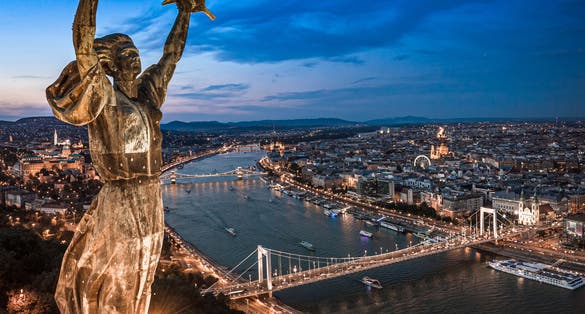 photo of Budapest, Hungary - Aerial panoramic view of Budapest from above, with Liberty Statue, Elisabeth bridge and Szechenyi Chain Bridge, Buda Castle, Matthias Church, Hungarian Parliament