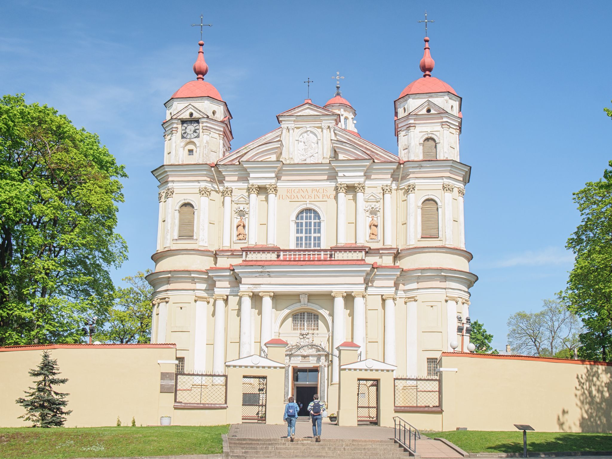 photo of tow tourist visiting church of st peter and st paul, Vilnius ,Lithuania.