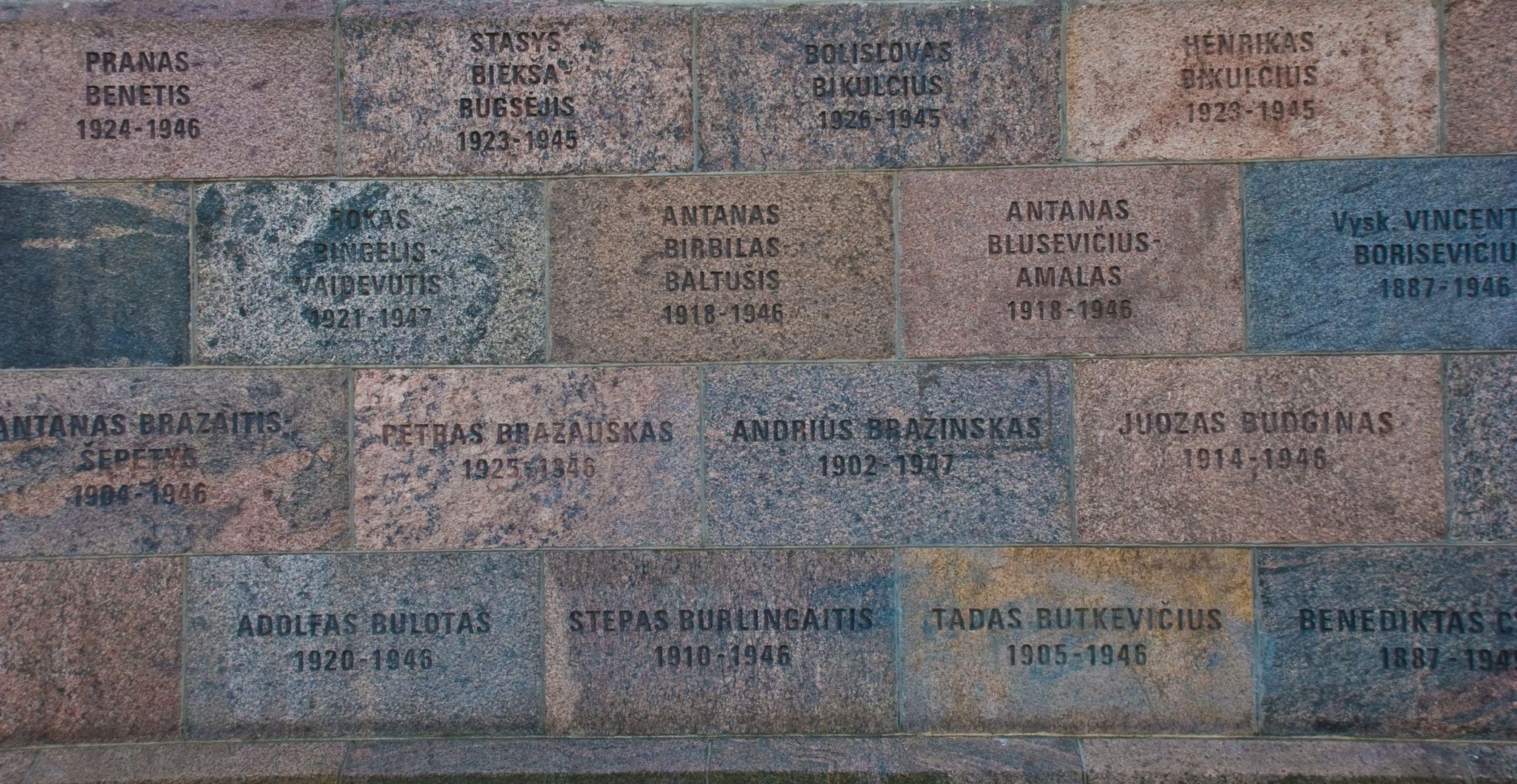 Wall outside the museum, engraved with names of those killed inside