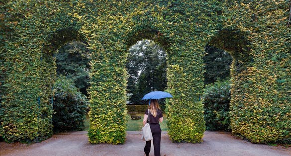 The gardens of The Musée Rodin in Paris, France with woman walking