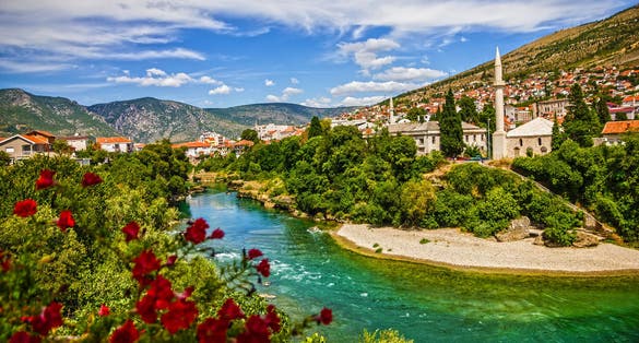 photo of view of Mostar, Bosnia and Herzegovina. Morning sun on Nerteva River and Old City of Mostar, Bosnia and Herzegovina.