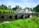 photo of view of Medieval Desmond Castle, Ireland with old stone bridge, Adare, County Limerick, Medieval Desmond Castle, Ireland with old stone bridge, Adare, County Limerick, Irland.