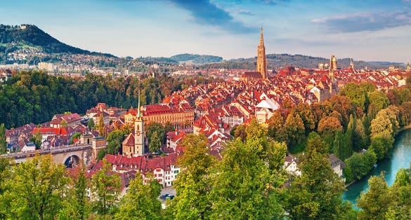 Photo of old town of Bern, capital of Switzerland, covered with colorful sunrise.