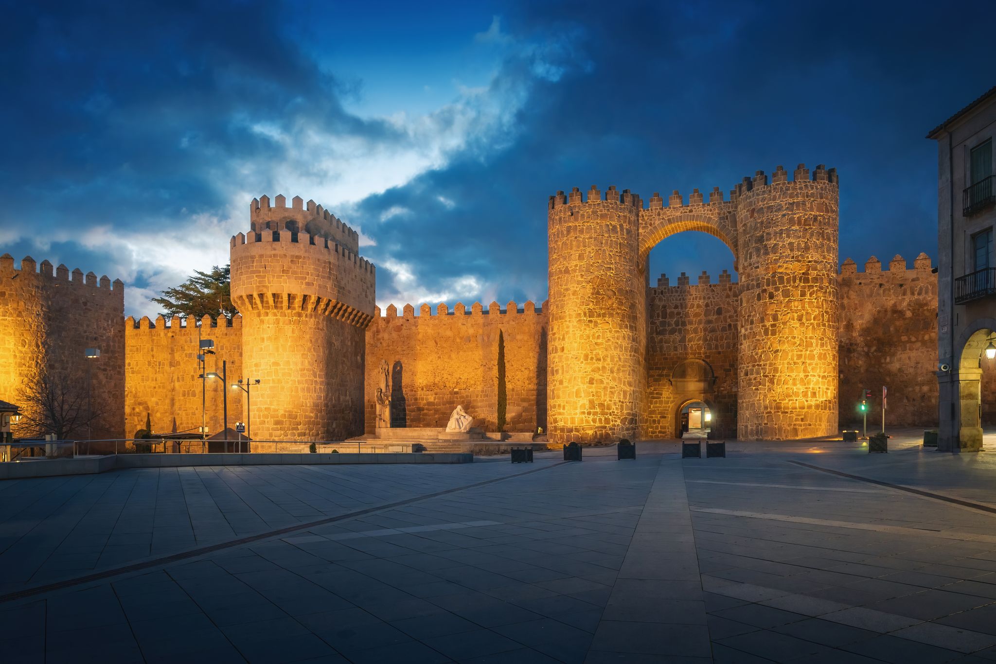photo of view of Puerta del Alcazar Gate and Torre del Homenage (Keep) of Medieval Walls of Avila at night - Avila, Spain