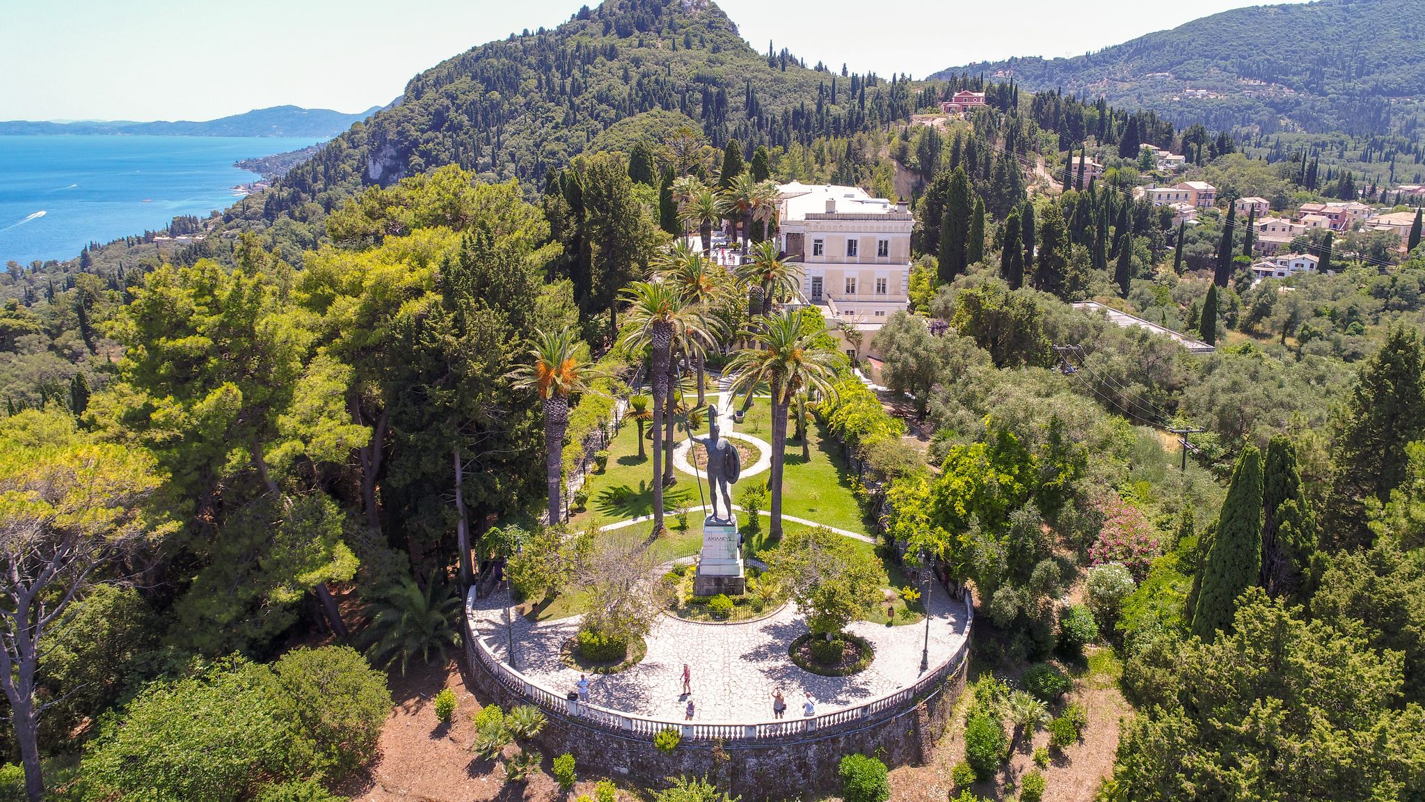 photo of view of View from drone to the Greek island of Corfu. In the frame of the sea, trees and a statue of Achilles. Gastouri, Greece.