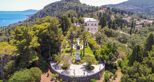 photo of view of View from drone to the Greek island of Corfu. In the frame of the sea, trees and a statue of Achilles. Gastouri, Greece.