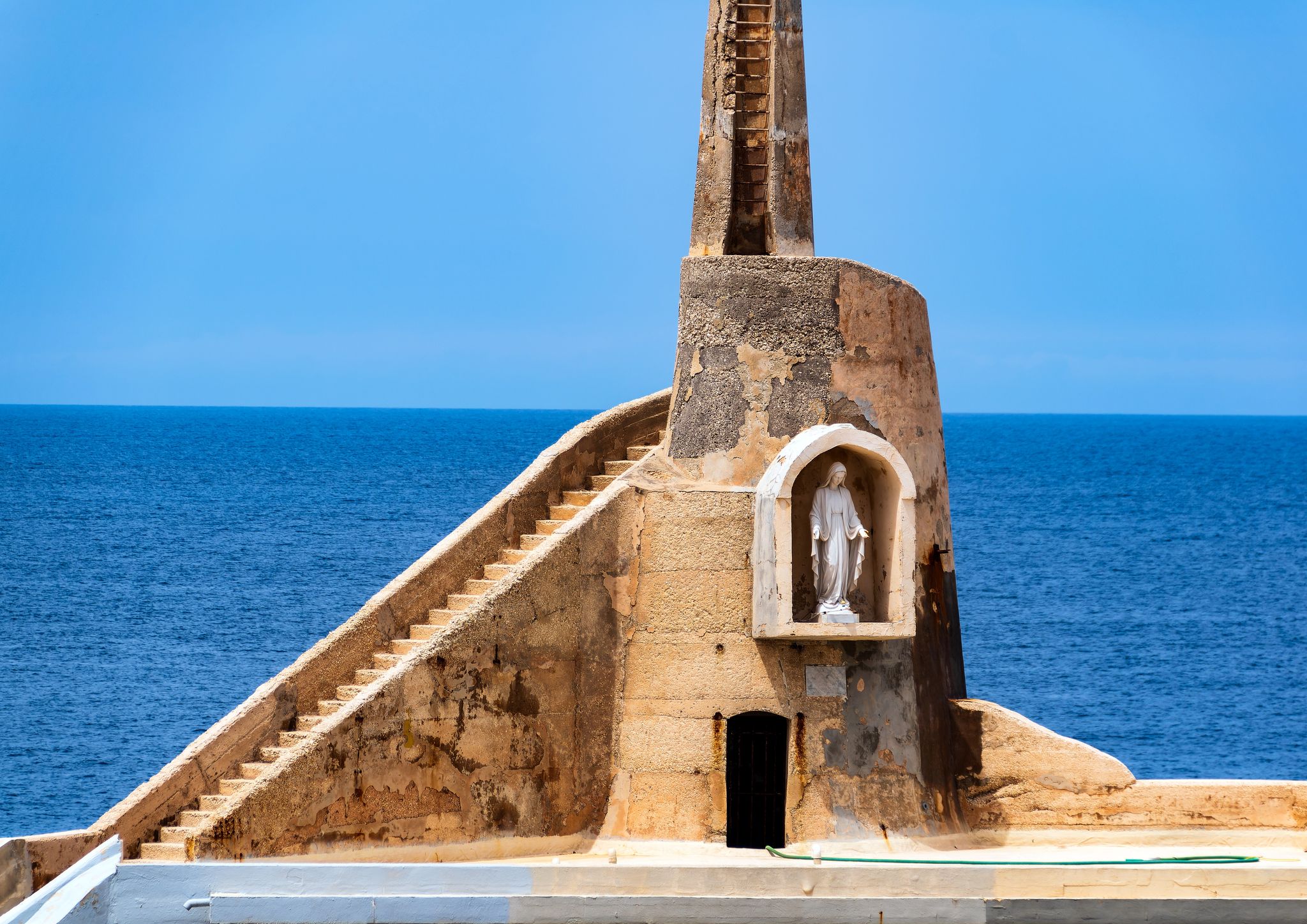 A statue of the Virgin Mary at one corner of Malta's Cirkewwa harbour where the Gozo ferry arrives.