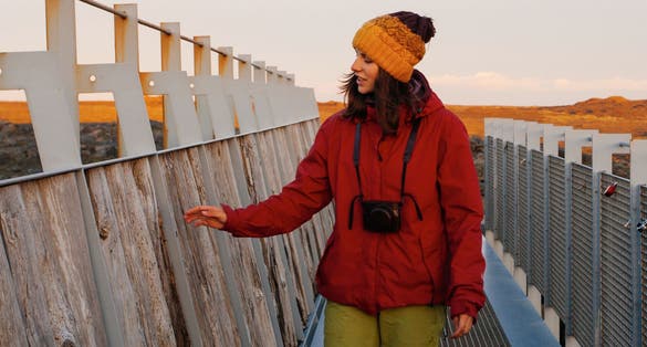photo of Woman traveling Iceland. In famous bridge between continents .