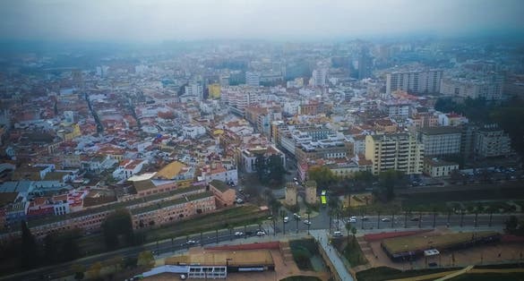 photo of aerial view of Badajoz city with Palms Gate at cloudy day. Spain.
