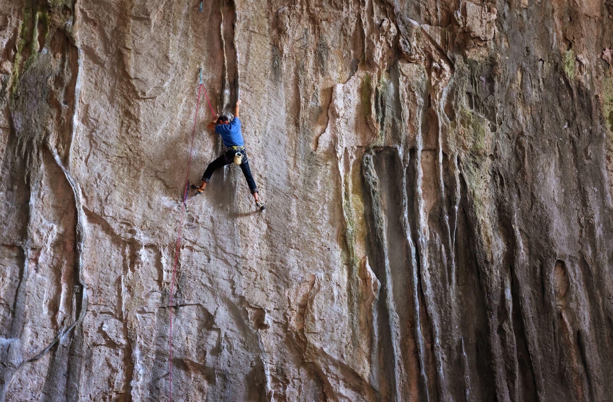 Photo of Rock climber in a famouse Bulgarian Cave Prohodna. Prohodna cave is also known as God's eyes near Karlukovo village, Bulgaria.