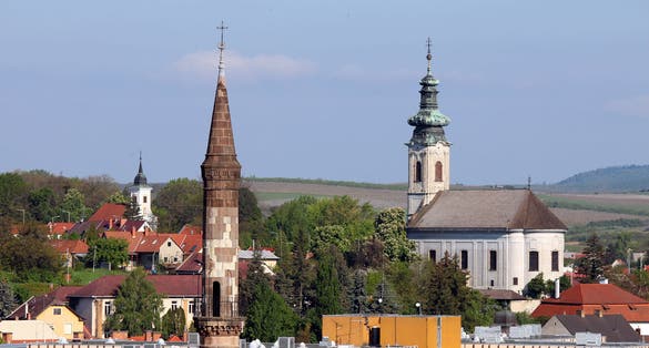 photo of view of minaret and churches different religions in one city Eger Hungary .