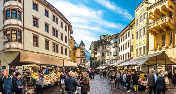 photo of view of Bolzano, italy - October 19: People shopping at a famous Market Square in the old town at october 19,2018 in Bolzano in Italy.