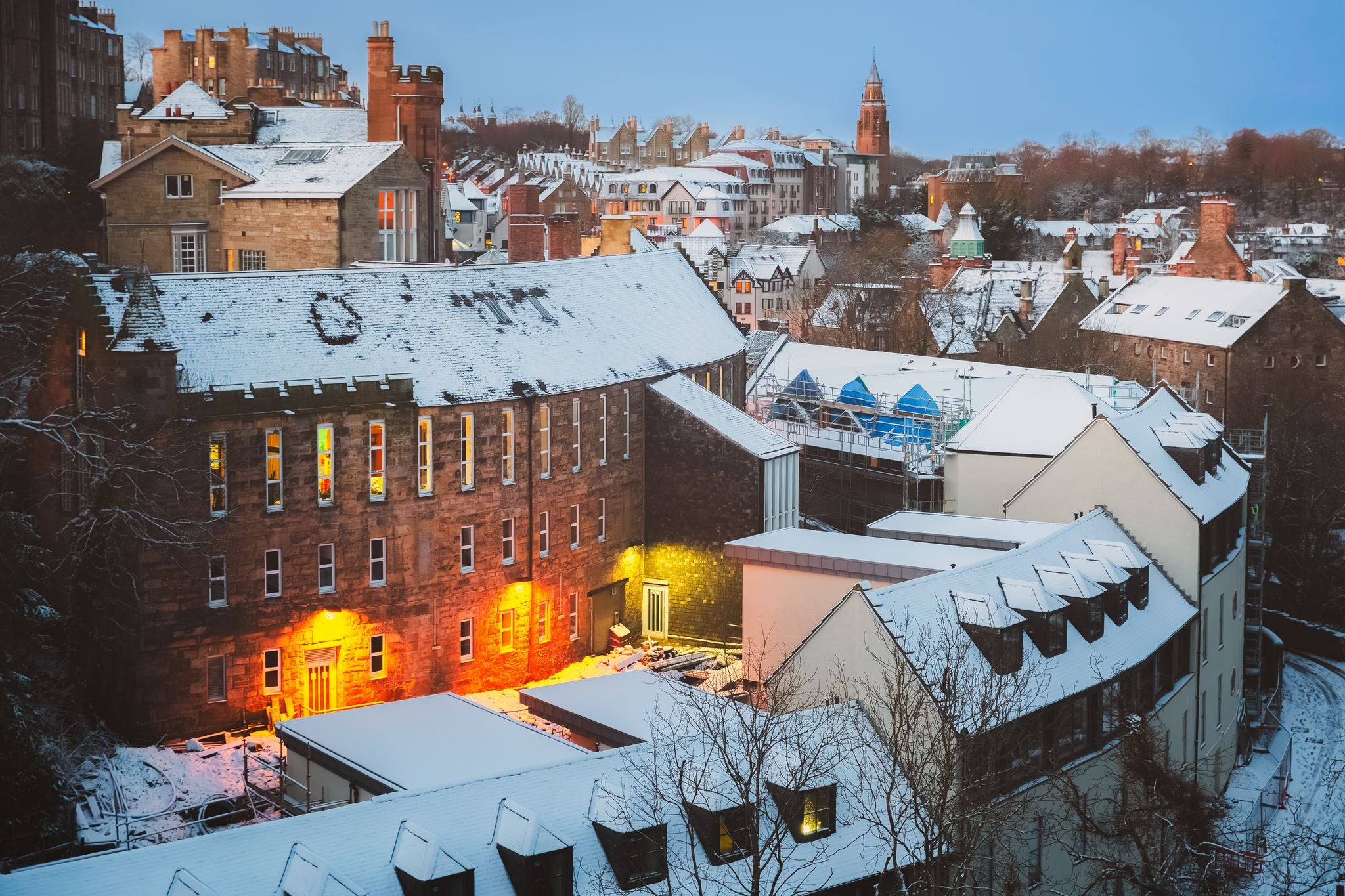 Quaint and historic Dean Village covered in snow along the Water of Leith during a winter twilight in Edinburgh, Scotland, UK.jpg