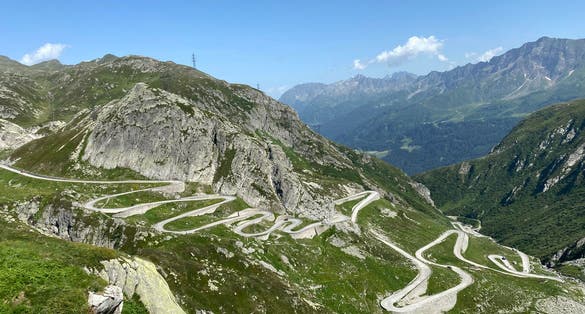photo of Mountain Road crossing St. Gotthard Pass (Gotthardpass or Passo del Sao Gottardo) in the Swiss Alps, Airolo - Canton of Ticino, Switzerland.