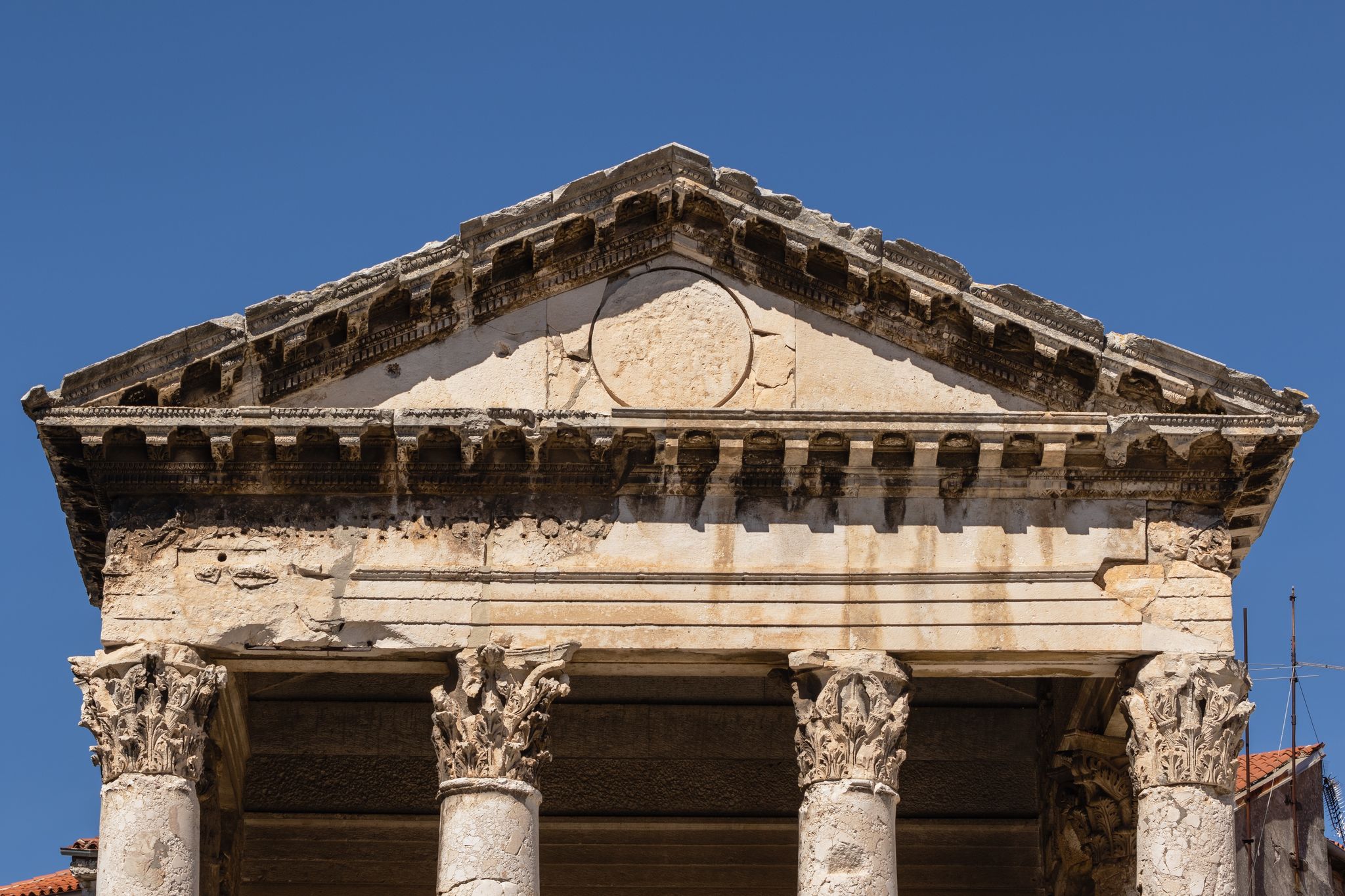 Photo of Close up of the pediment of the temple of Augustusin the center of Pula, Croatia.