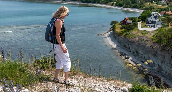 Woman walking and bicycling in summer.