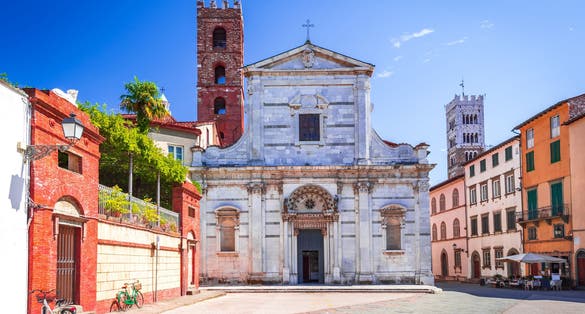photo of view of Lucca, Italy - View of Piazza San Giovanni and famous St Martin Cathedral tower in background, postcard of Tuscany.