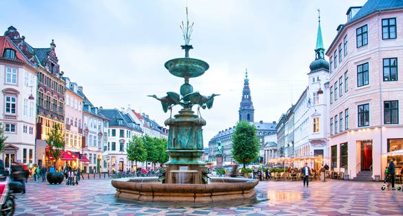 Photo of Stork Fountain on the Amagertorv (Amager Square) and the longest pedestrian street in the world Stroget in Copenhagen, Denmark.