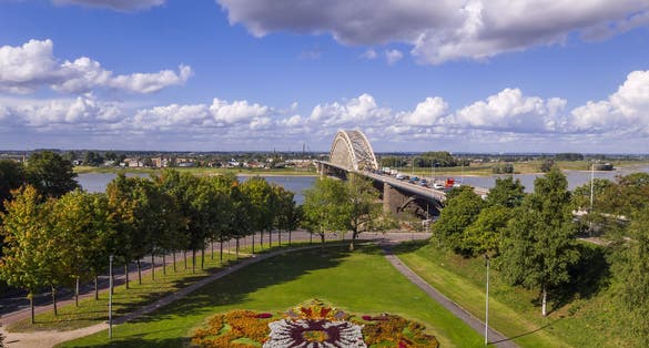 Bridge over the river Waal in Nijmegen, Holland with park and coat of arms of the city in flowers