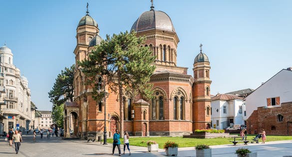 Photo of People are walking in streets near Saint Elias Church. Built 1890. Craiova. Romania.