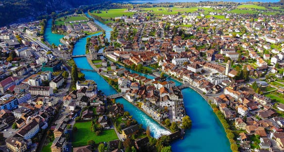 Photo of Aerial view over the city of Interlaken in Switzerland - amazing drone footage .