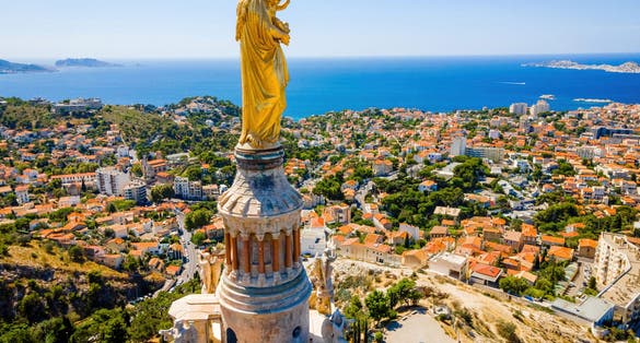 Photo of The aerial view of Basilique Notre-Dame-de-la-Garde in Marseille, a port city in southern France.