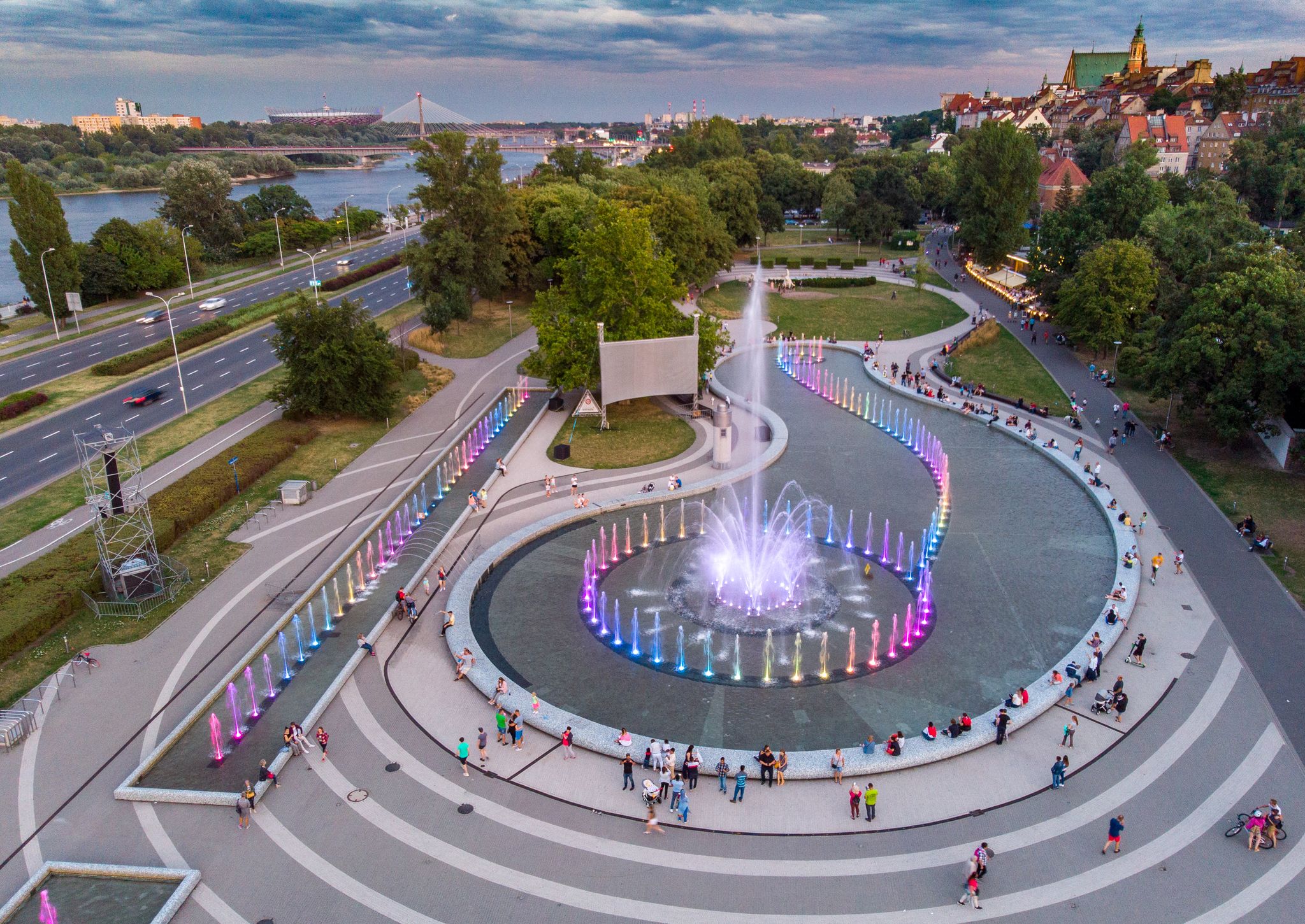 Photo of aerial view of Multicolored fountain illuminated in Warsaw, Poland.