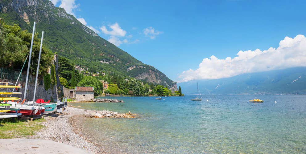 gargnano beach at coastline lake Gardasee, italy. summer landscape with blue sky and clouds