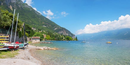 gargnano beach at coastline lake Gardasee, italy. summer landscape with blue sky and clouds
