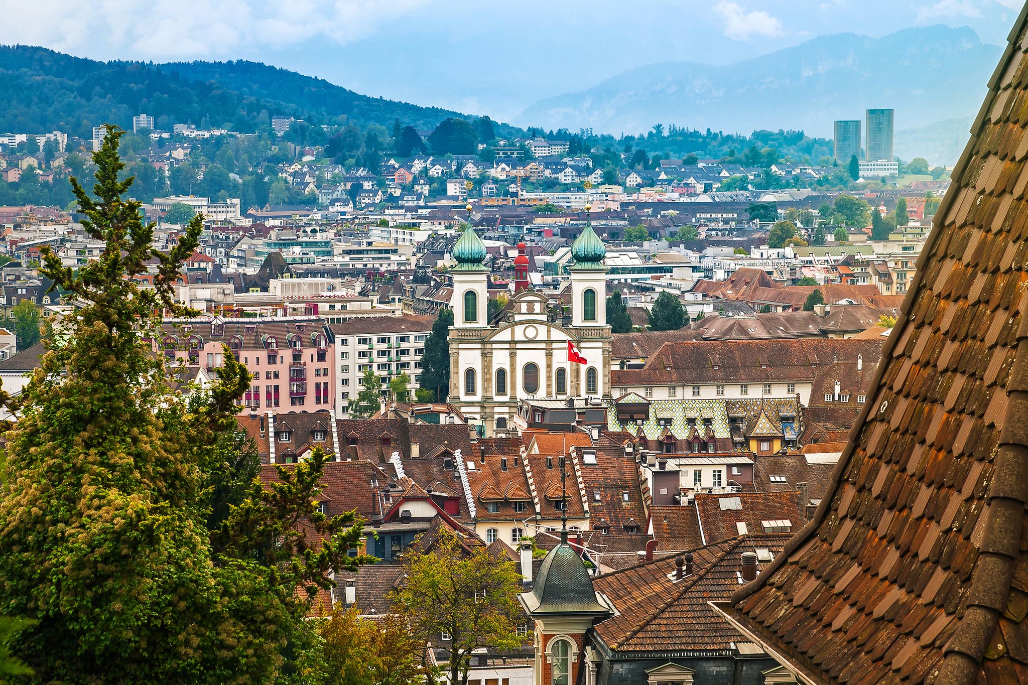 photo of aerial cityscape of Lucerne from city wall with Jesuit Church St Francis Xavier, Lucerne, Switzerland.