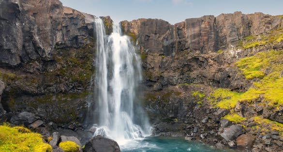photo of view of Beautiful view of Gufufoss waterfall flowing thourgh rocks in summer at Seydisfjordur, East of Iceland.
