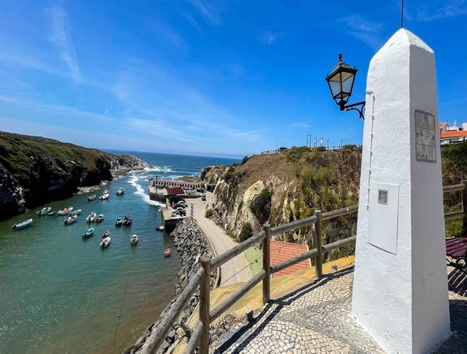 Small fishing boats anchored near the shore in Vila Nova de Milfontes, a peaceful retreat in Portugal in August..jpg