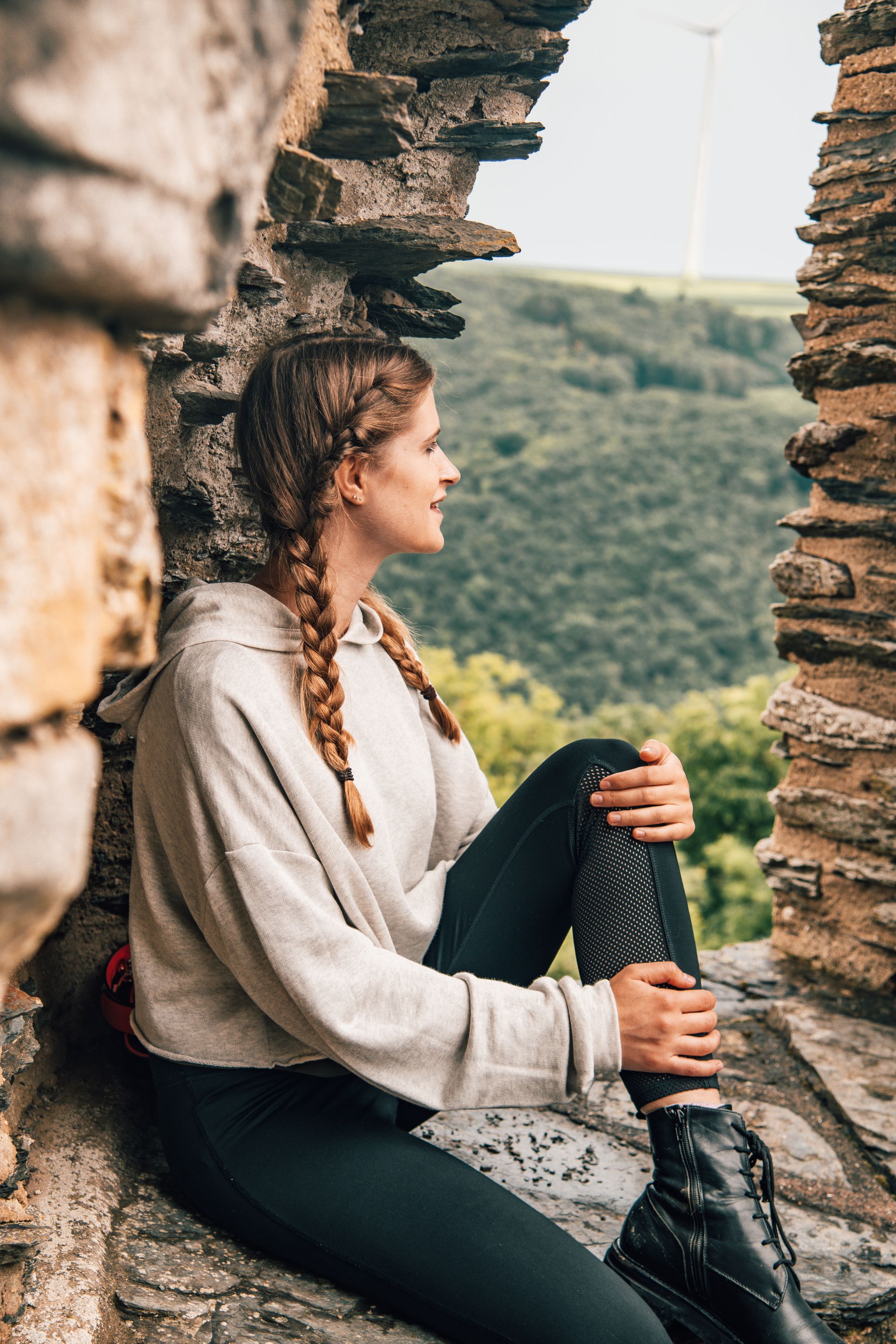 photo of girl in bourscheid castle in Luxembourg. The tower of the castle.