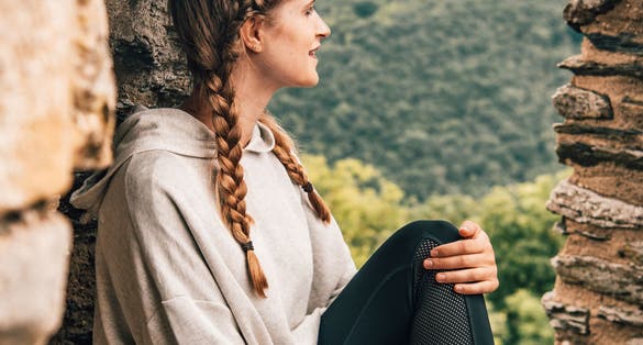 photo of girl in bourscheid castle in Luxembourg. The tower of the castle.