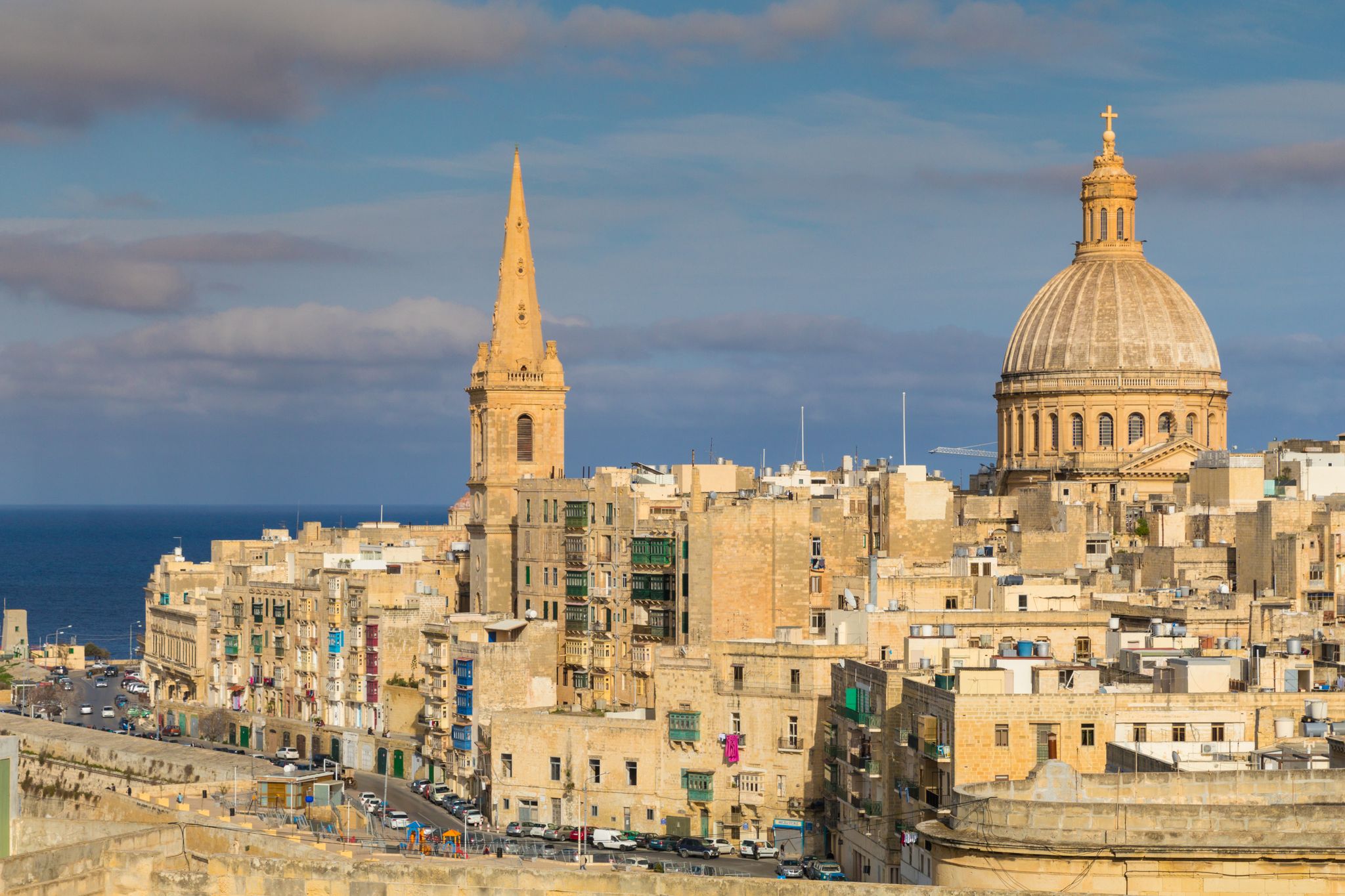 Beautiful skyline view of Capital city of Malta, Valletta, Dome and bell-tower above the walls, blue skies, from the St. Andrew Bastion, Valletta, Malta.