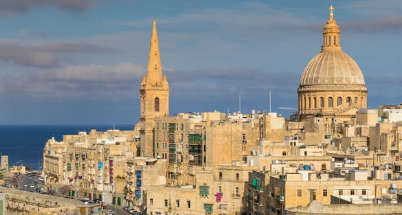 Beautiful skyline view of Capital city of Malta, Valletta, Dome and bell-tower above the walls, blue skies, from the St. Andrew Bastion, Valletta, Malta.