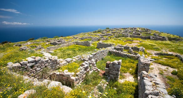 photo of view of The ruins of ancient Thira, a prehistoric village at the top of the mountain Mesa Vouno, Santorini, Greece.