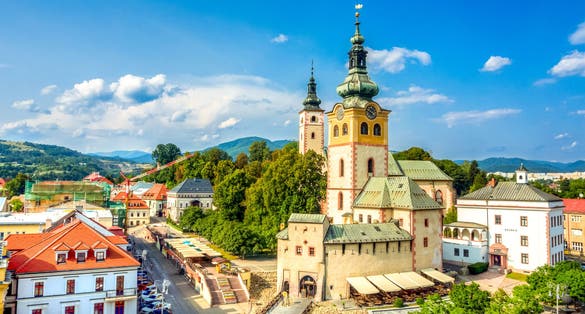 Photo of view of main square in Banska Bystrica, Slovakia from above during summer day with historical fortification.