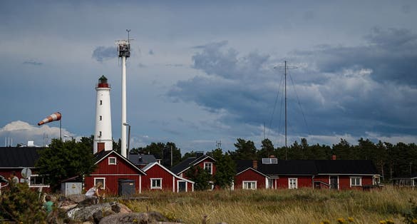 Photo of Marjaniemi lighthouse with red cabins, Denmark.