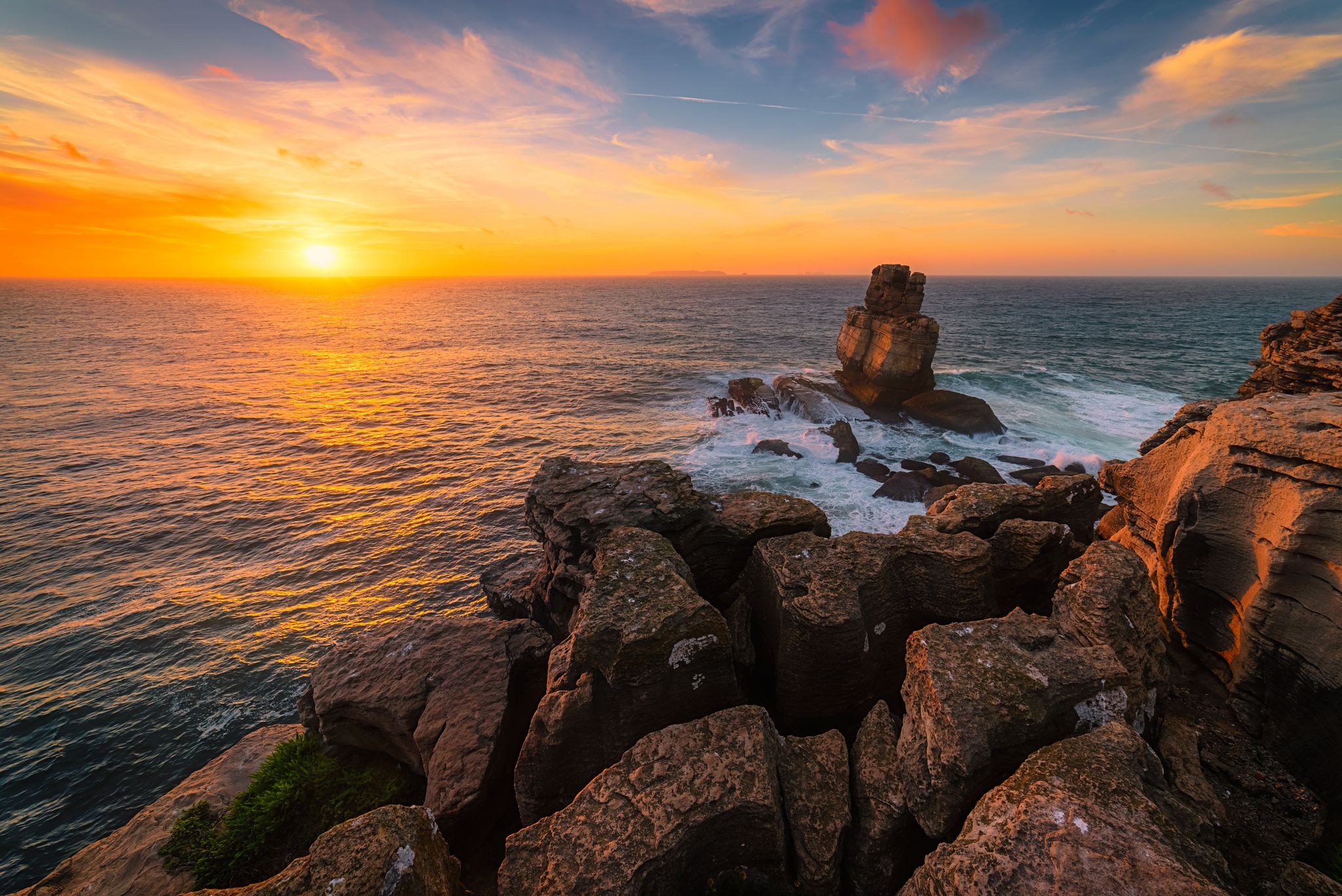 The Cabo Carvoeiro rocky coast in Portugal / The Cabo Carvoeiro / Magical sunset at The Cabo Carvoeiro in Portugal
