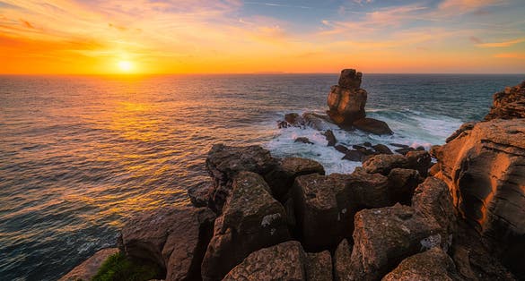 The Cabo Carvoeiro rocky coast in Portugal / The Cabo Carvoeiro / Magical sunset at The Cabo Carvoeiro in Portugal